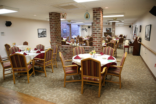 A spacious dining area featuring elegantly set tables and a cozy atmosphere.