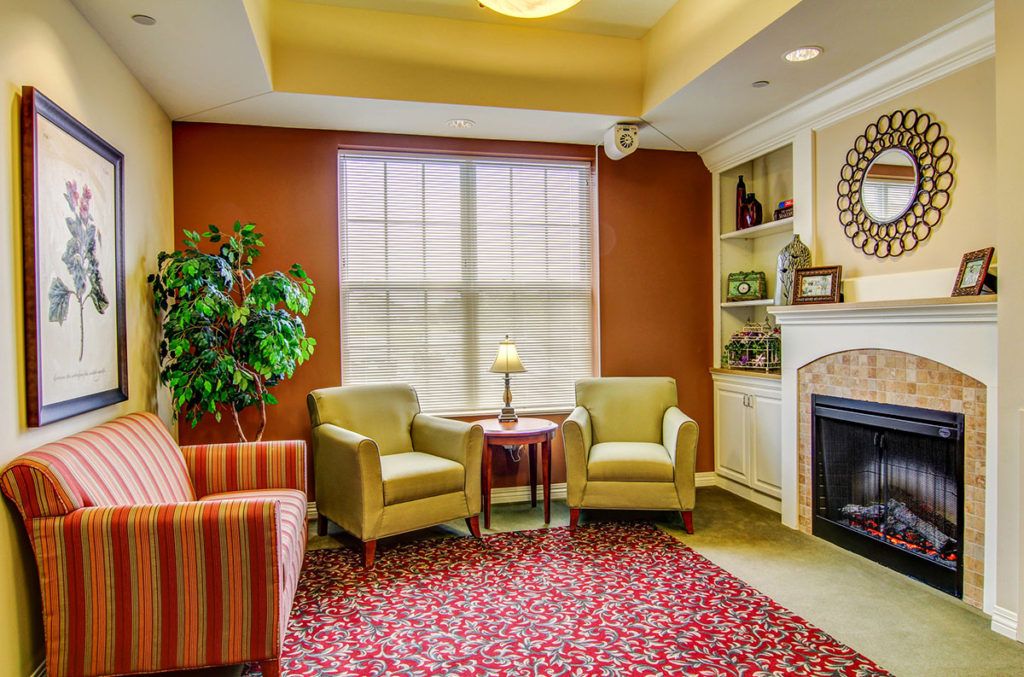 A cozy living room with comfortable seating, a fireplace, and warm colors.