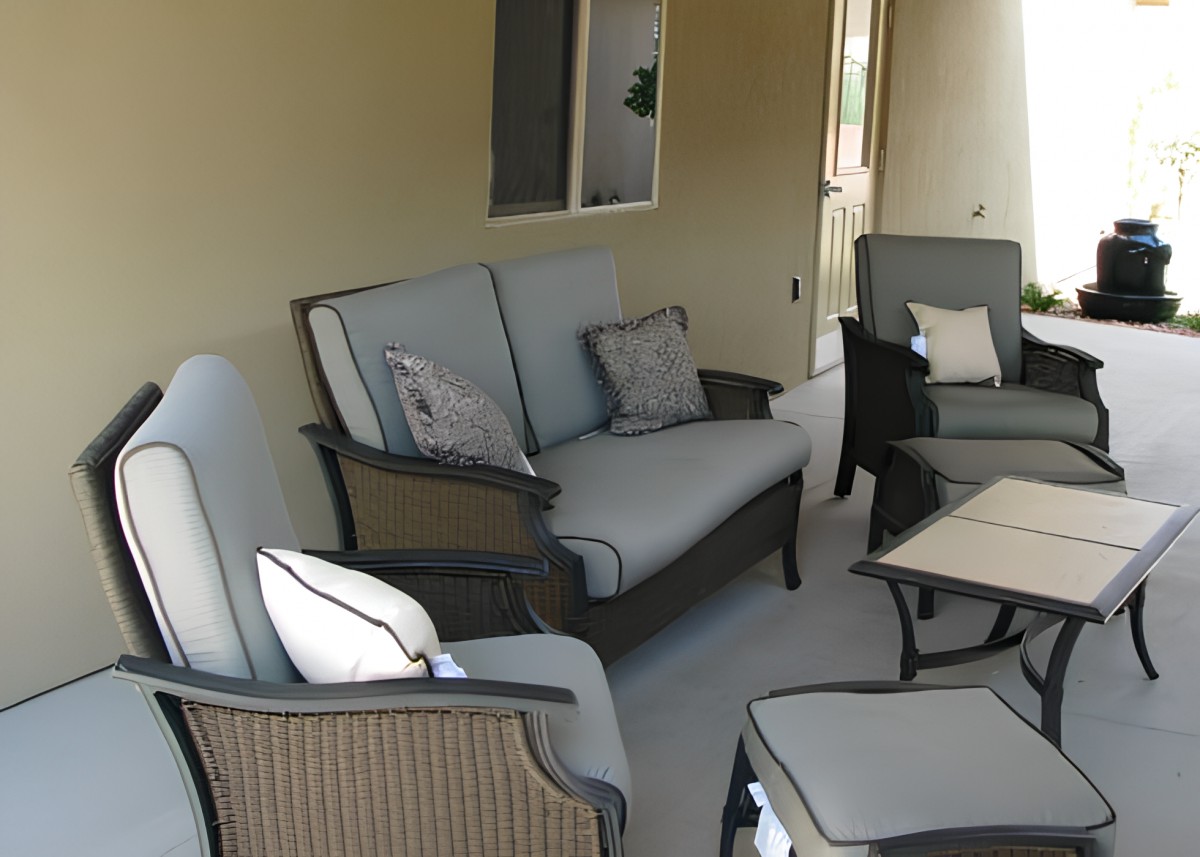 A cozy outdoor patio setup with comfortable seating and cushions.
