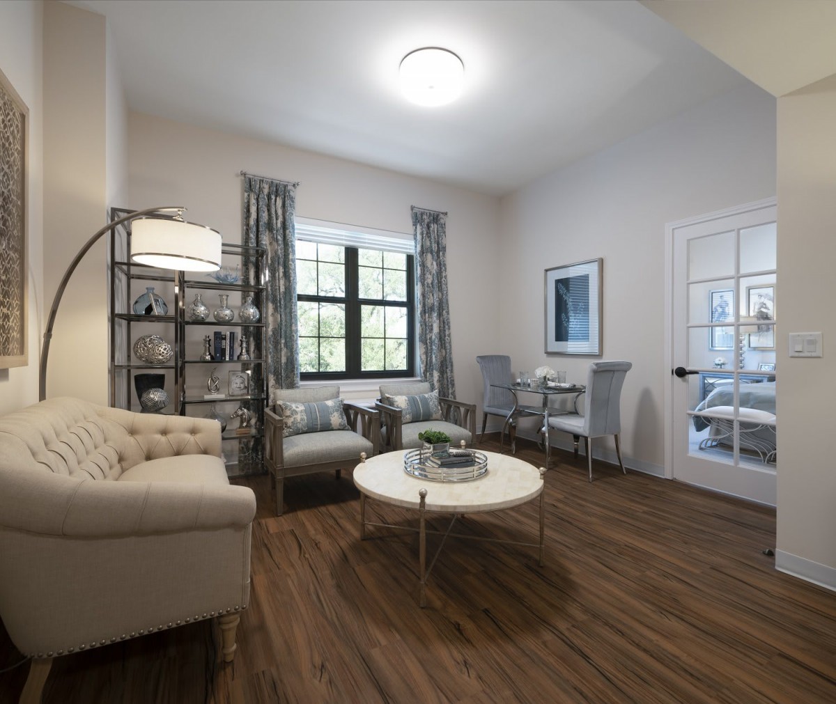 A modern and cozy living room with minimalist design, featuring a sofa, coffee table, and floor lamp.