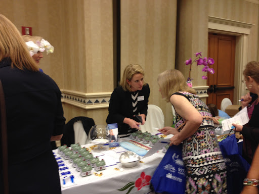 Attendees engaging at a booth during a conference event.