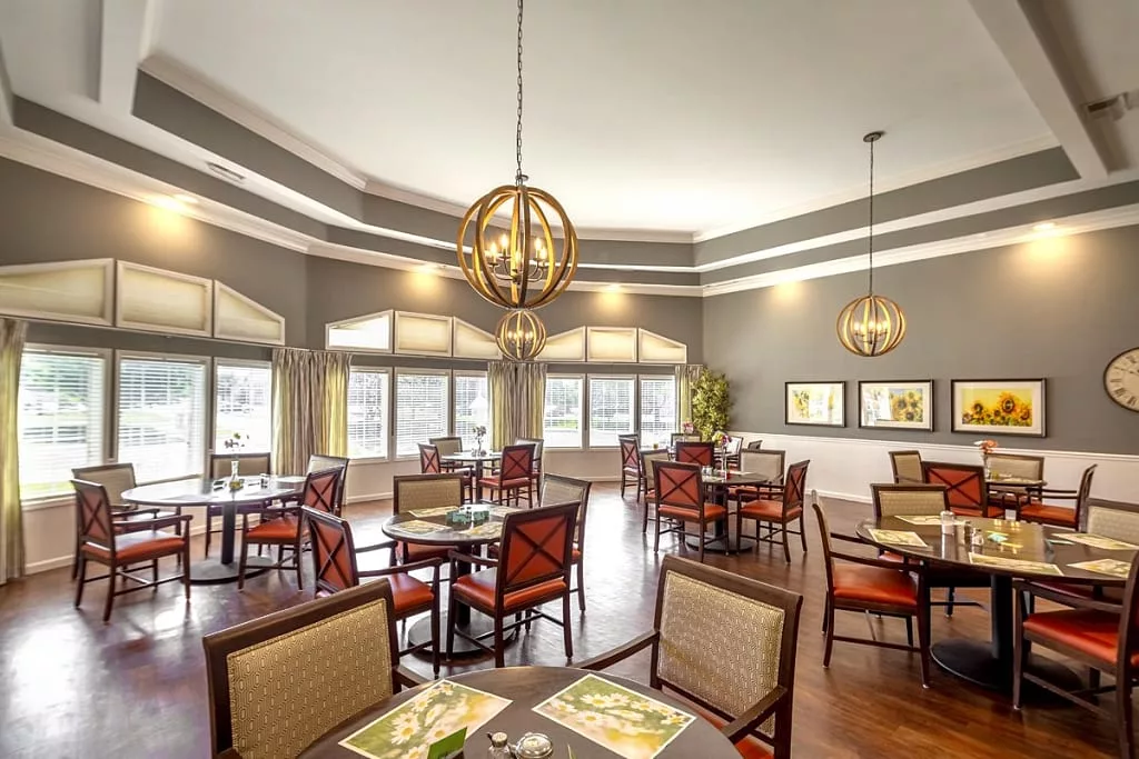 A modern dining area with elegant lighting and spacious seating.