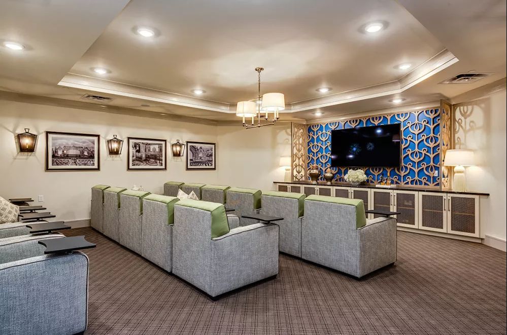 A cozy home theater with comfortable seating and a large TV.