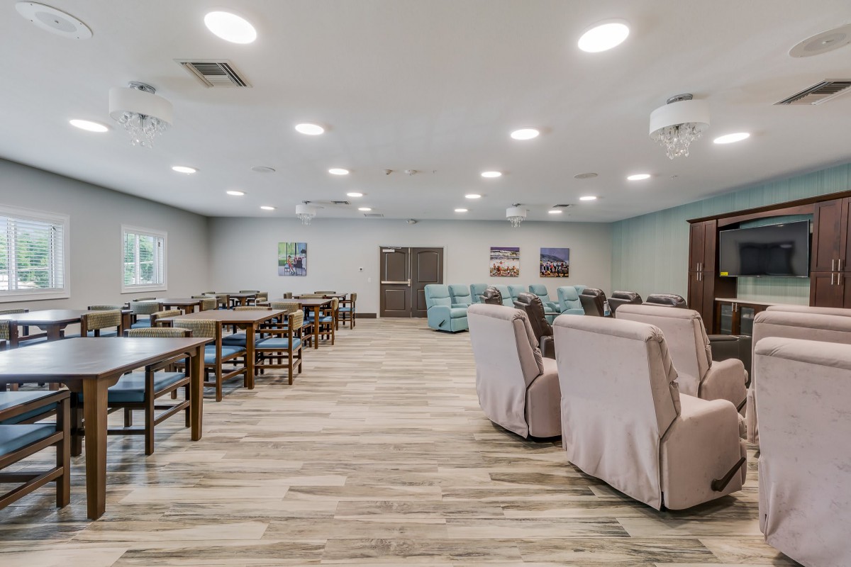 A modern dining area with tables and chairs arranged neatly in a well-lit space.
