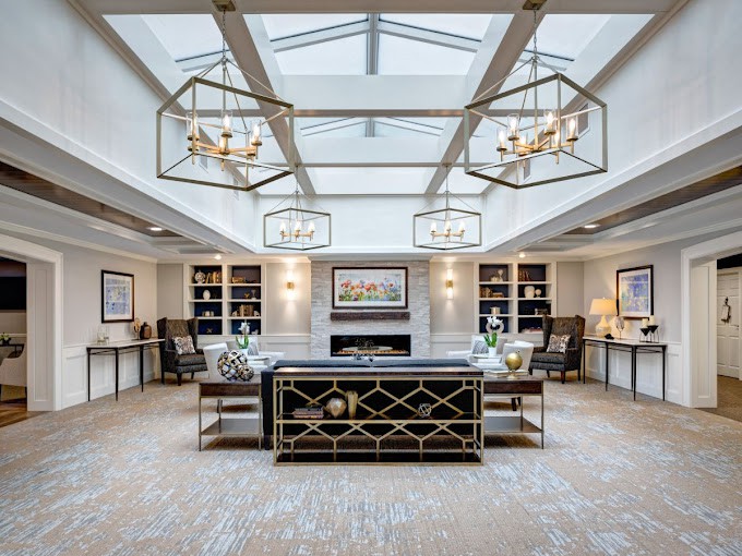 A luxurious lobby interior featuring elegant chandeliers, a skylight, and sophisticated decor.