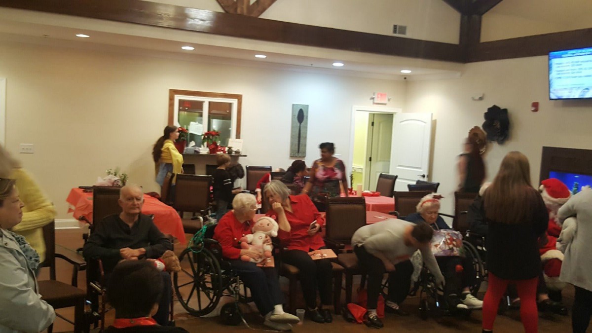 A group of seniors participating in a community gathering indoors.