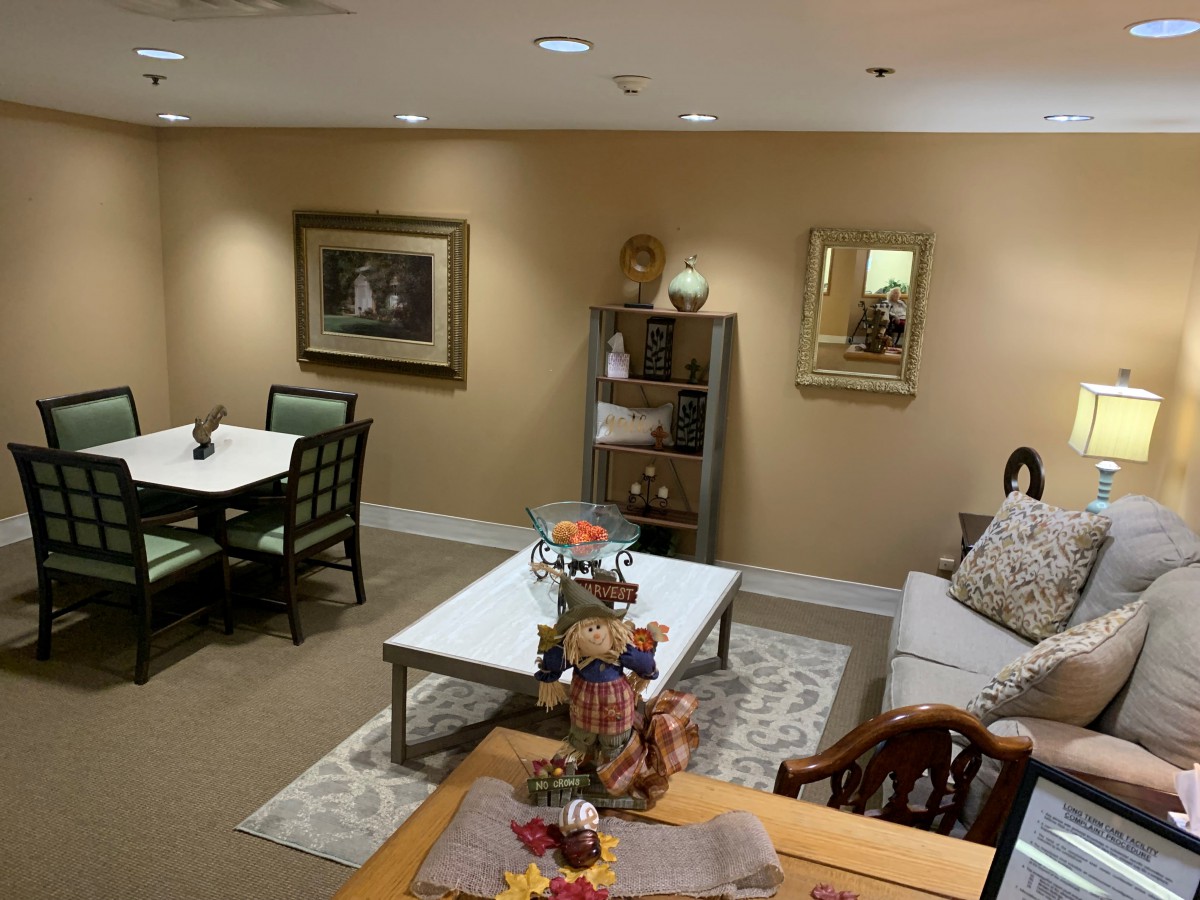 A cozy living room with a sofa, tables, and decorative items.