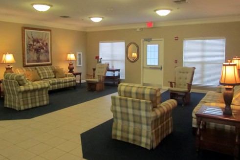 A cozy living room with plaid furniture and soft lighting.