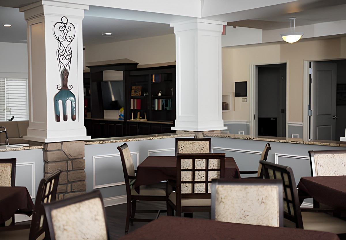 A cozy dining area with elegant tables and chairs, featuring tasteful decor.