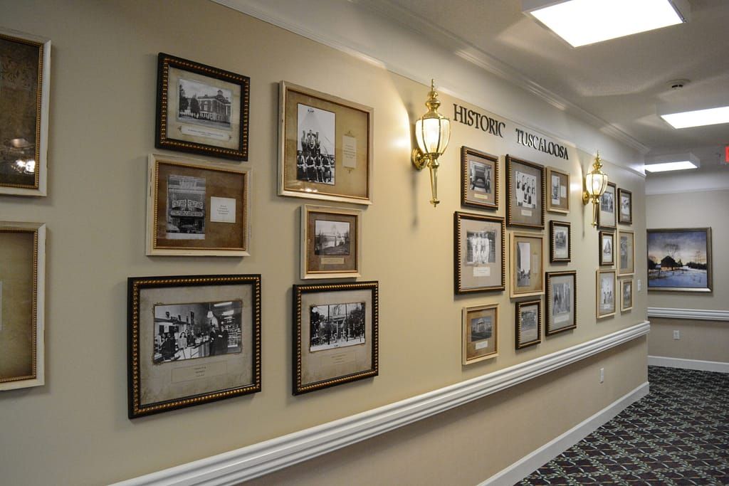 A hallway gallery displaying framed historical photographs on a wall.