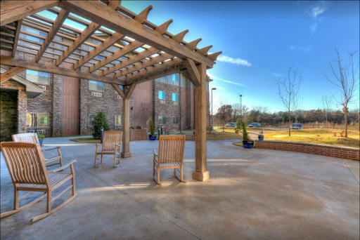 A serene outdoor seating area under a wooden pergola, perfect for relaxation.