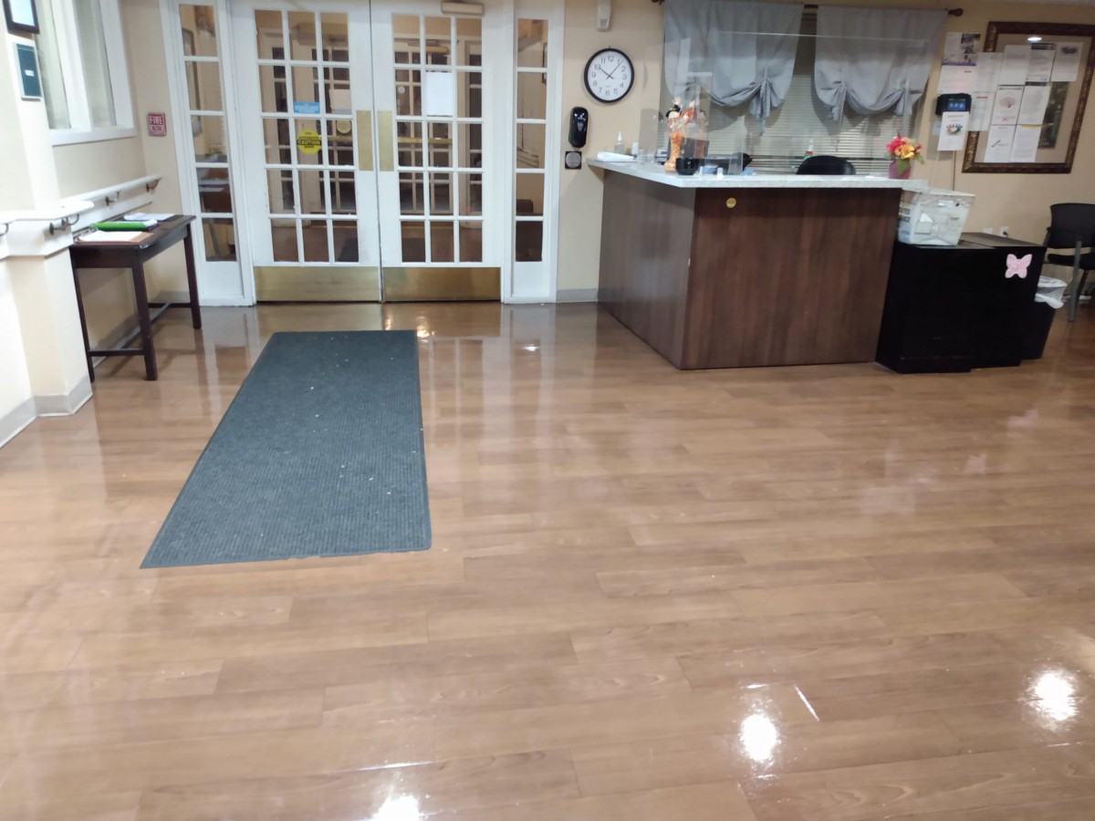 A clean lobby area with a reception desk and double doors.
