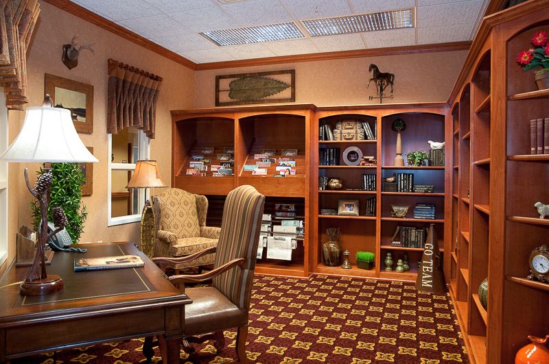 A cozy office space with wooden bookshelves and elegant furniture.