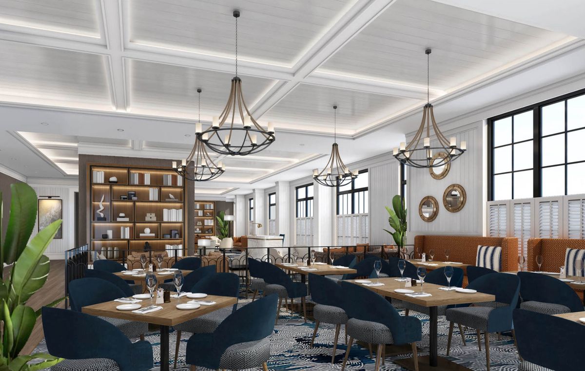 A modern restaurant interior with elegant chandeliers and cozy seating.