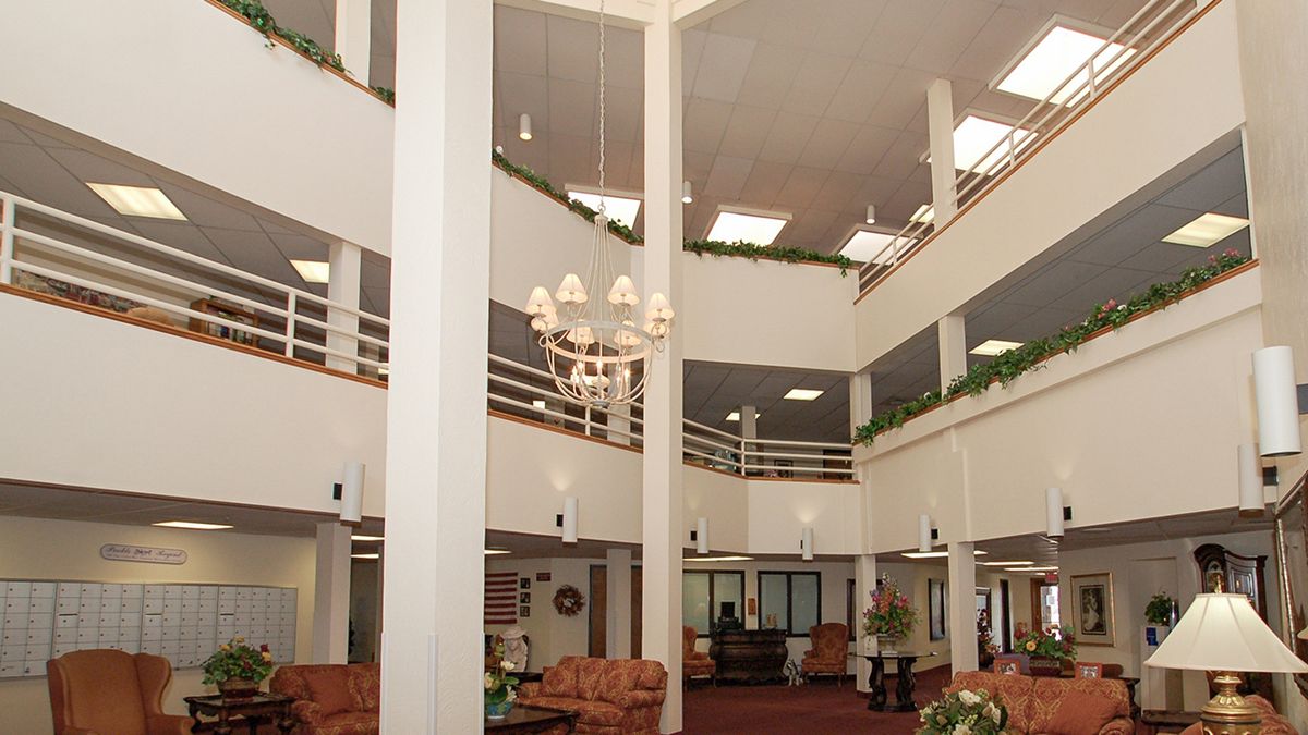 A spacious multi-level lobby with a central chandelier and comfortable seating areas.