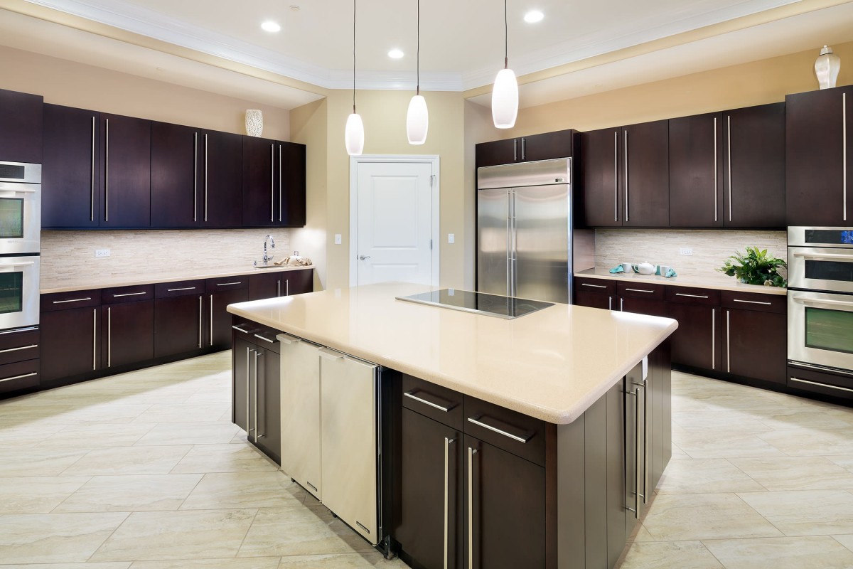 A modern kitchen with dark cabinets and a central island.