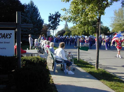 A gathering of seniors enjoying a community event outdoors.