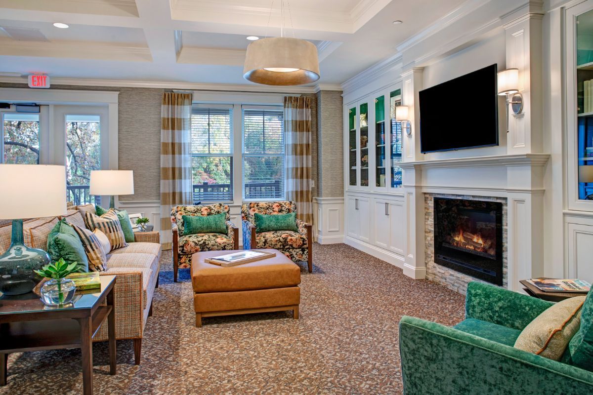 A cozy living room with a fireplace, television, and comfortable seating.