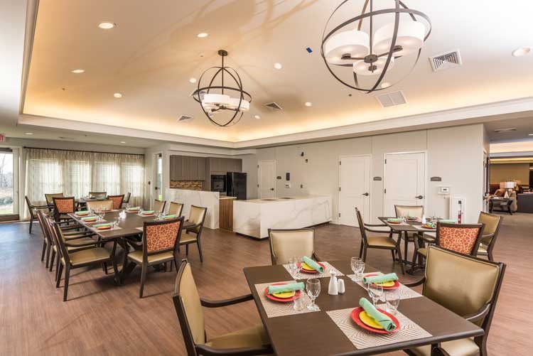 A modern dining room with elegantly set tables and stylish lighting.