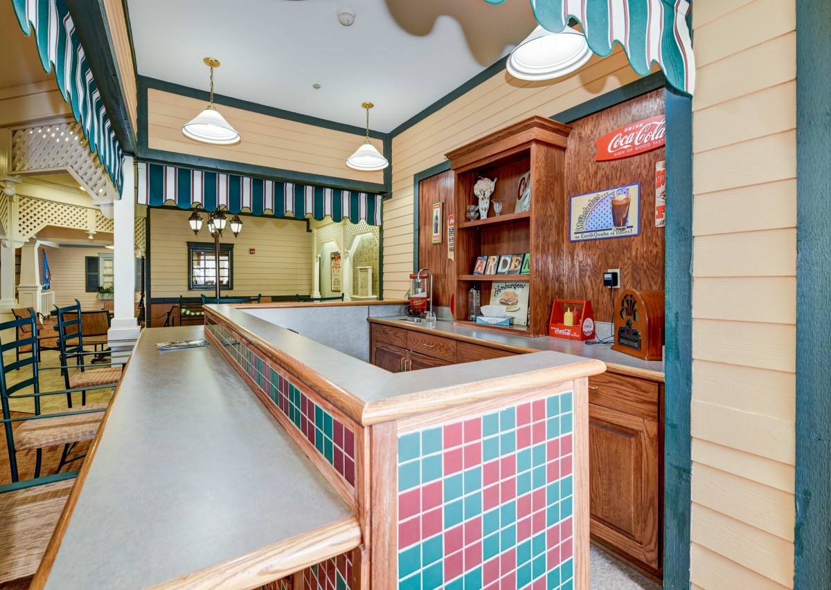 Interior view of a bar or restaurant with a tiled counter and decorative elements.