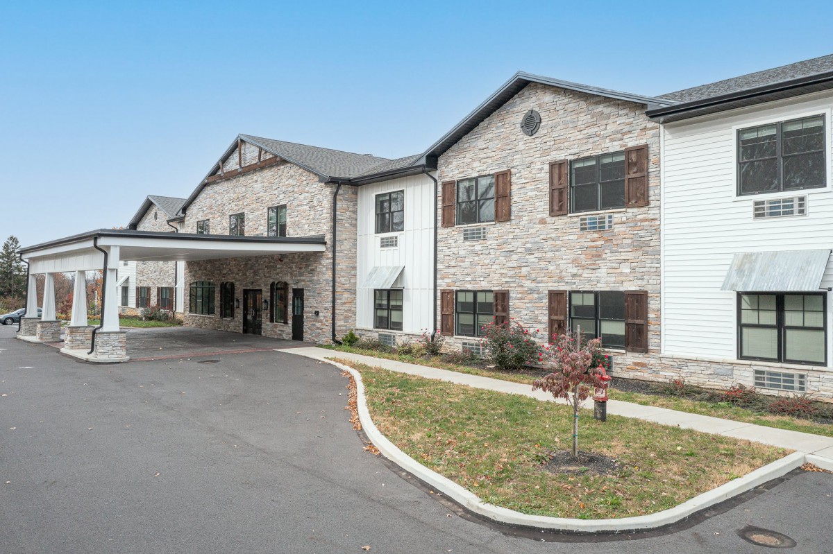 A modern building with a stone facade and a welcoming front entrance.