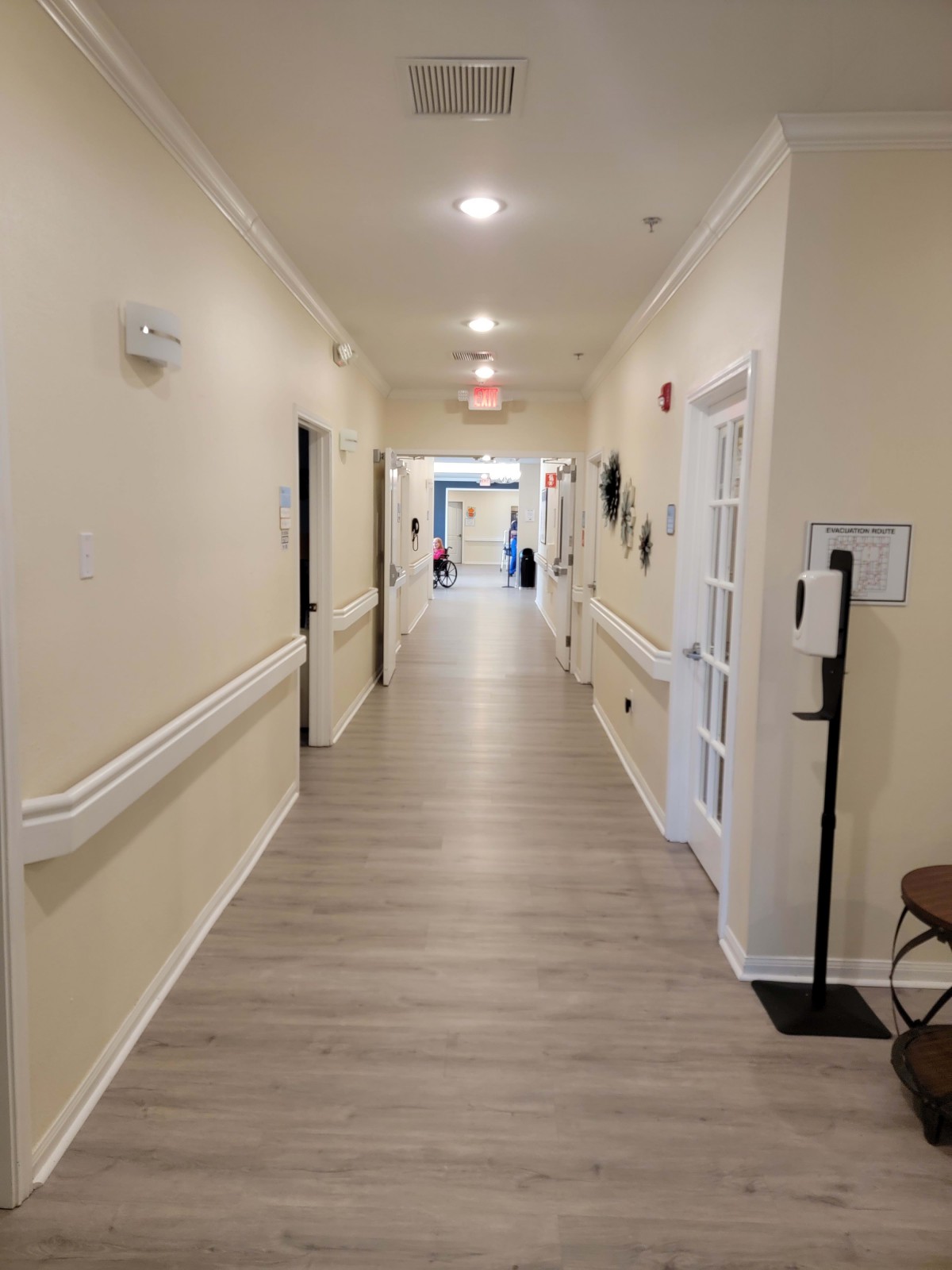 A brightly lit hallway with doors on either side.