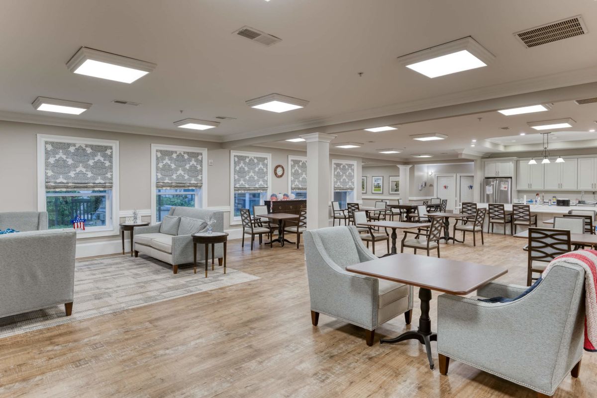 A spacious and modern dining area with tables, chairs, and decorative elements.