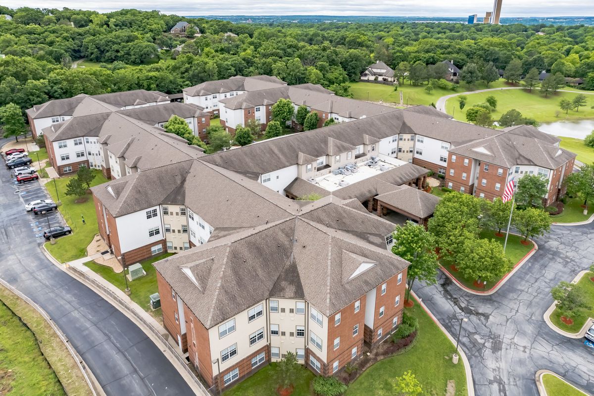 Aerial view of a large residential complex surrounded by greenery.