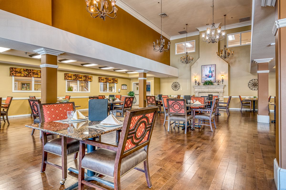 Elegant dining room with chandeliers and stylish decor.