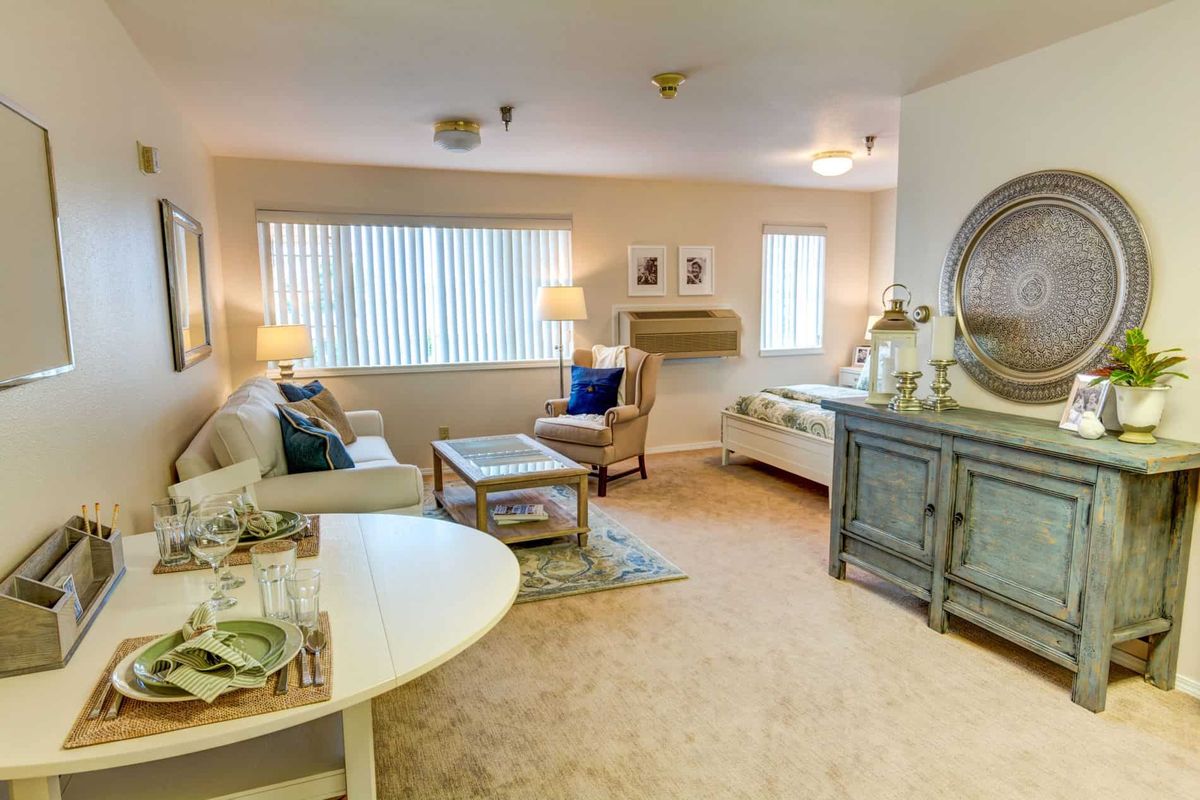 A cozy living room with comfortable seating and warm lighting.