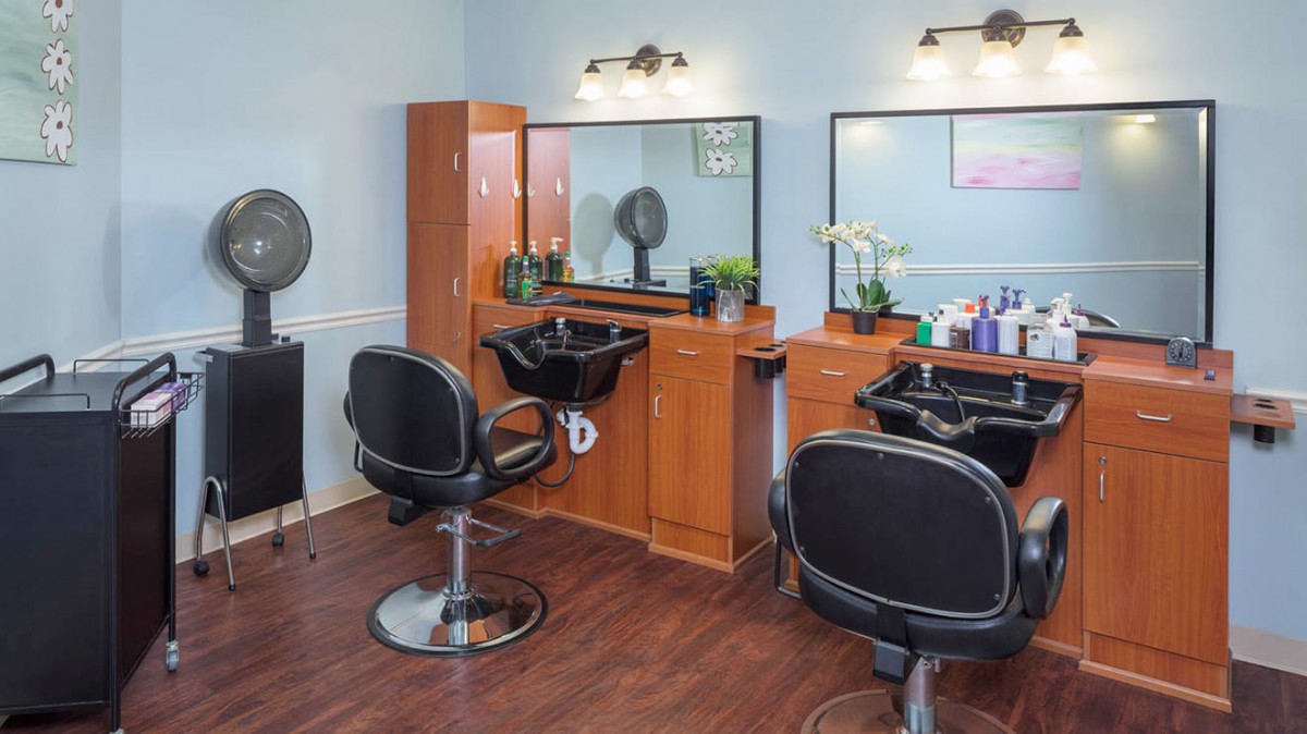 A cozy hair salon interior with styling chairs and mirrors.