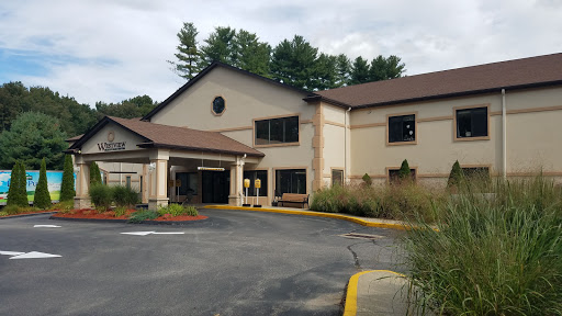 A modern commercial building featuring a welcoming entrance and landscaped surroundings.