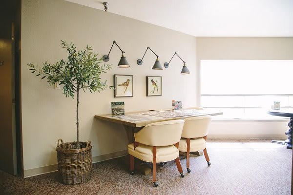 A cozy home office setup with a shared desk, comfortable chairs, and stylish decor.