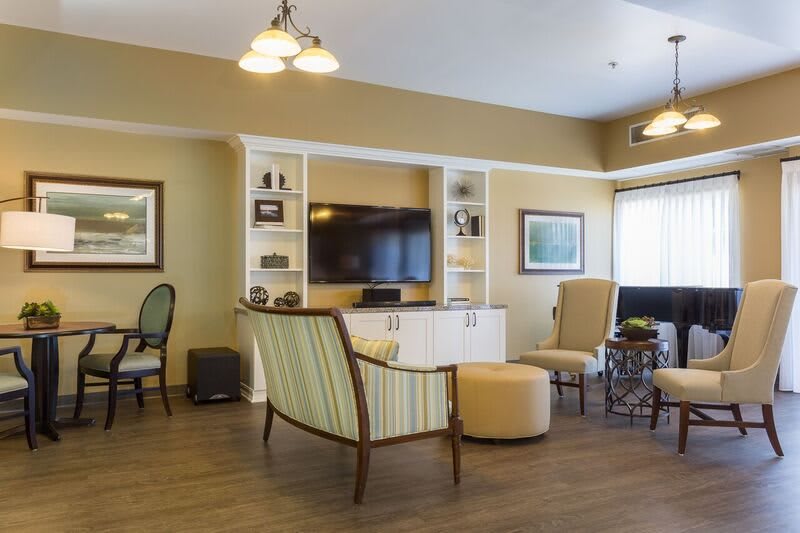 A cozy living room with comfortable seating and a large television.