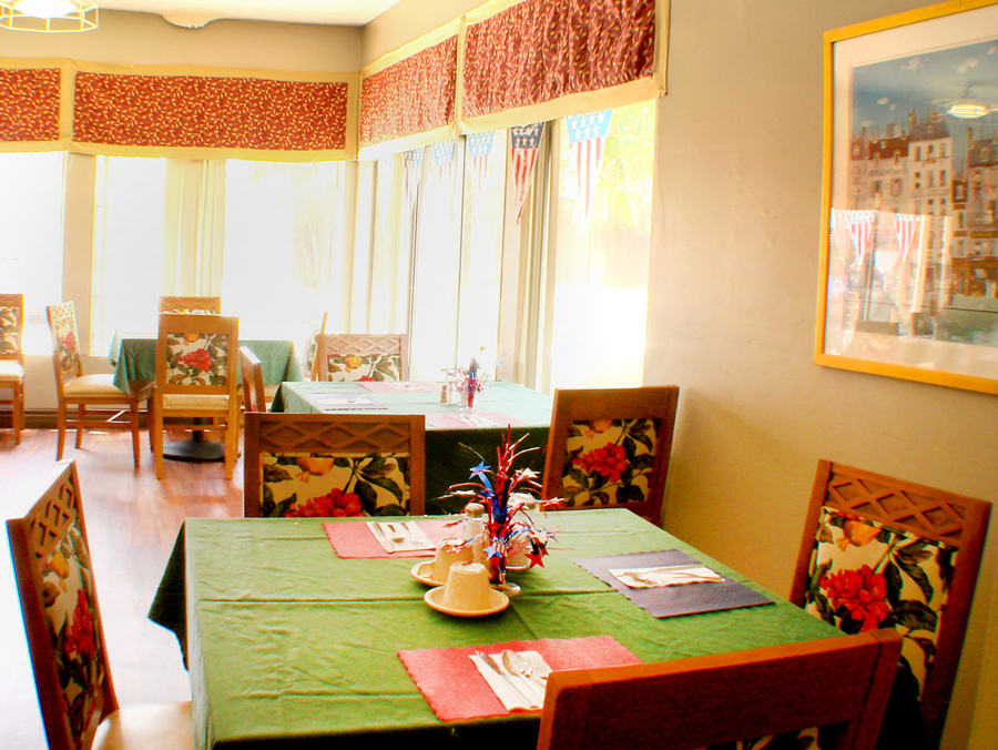 A cozy restaurant interior with tables set for dining.