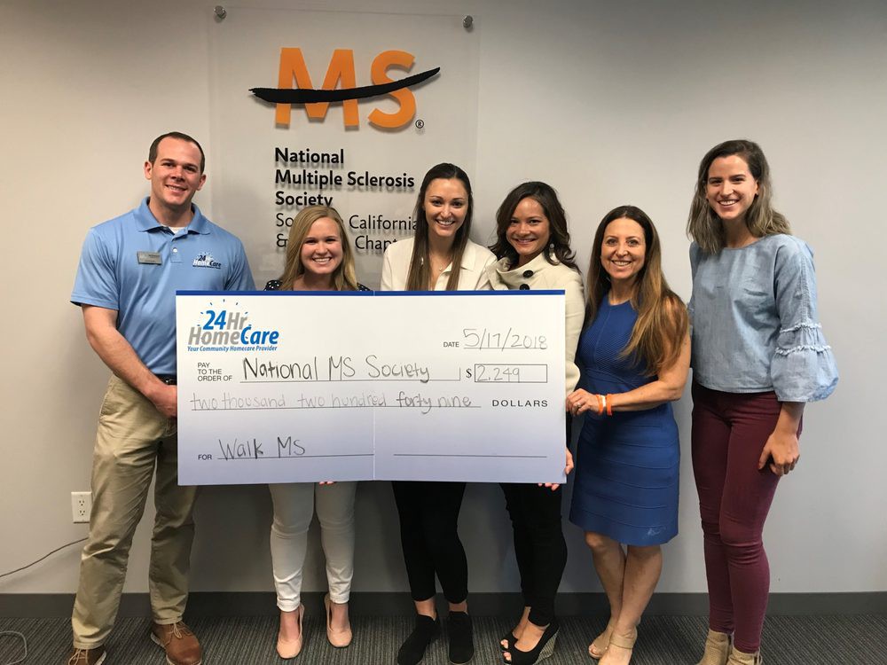 Group presenting a donation check to a charity organization.