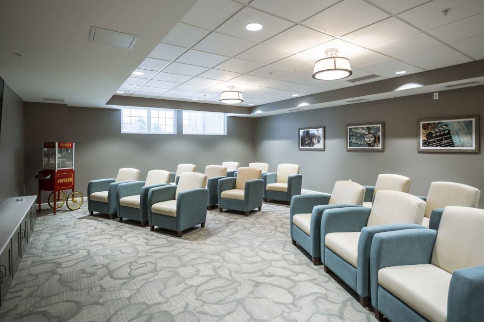 A modern waiting room with comfortable armchairs and soft lighting.