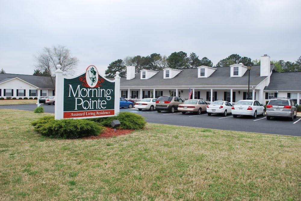 A view of a building with a parking lot and a sign reading 'Morning Pointe'.