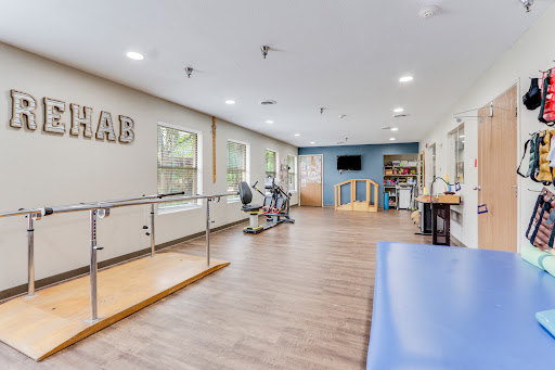A modern physical therapy room equipped with rehabilitation tools and exercise equipment.