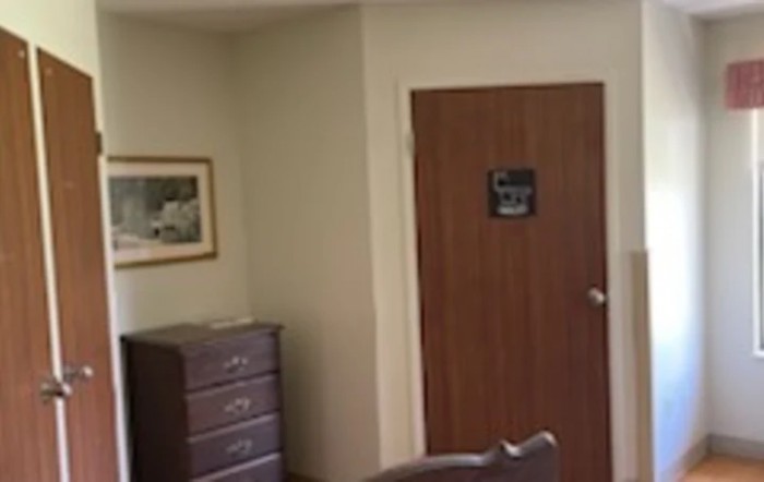 An interior office space with a wooden door and furniture.