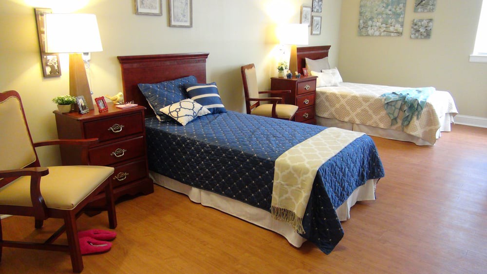 A cozy bedroom with two twin beds and wooden furniture.