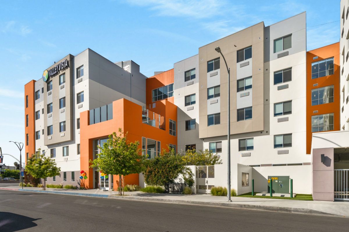 A modern apartment building with a colorful facade on a sunny day.
