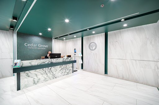 A sleek and modern reception area featuring marble elements and green accents.