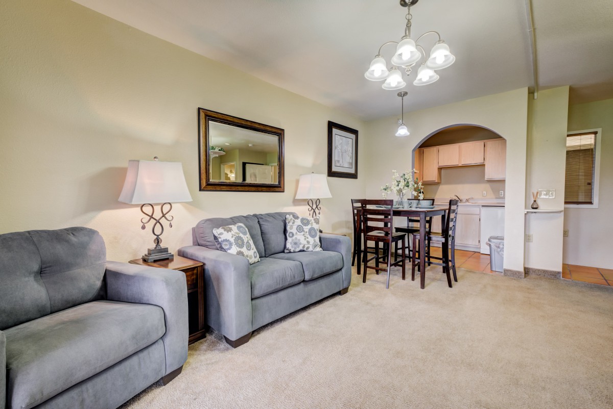 A cozy living and dining area with modern furniture and decor.