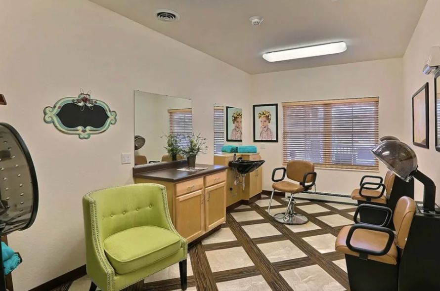 A modern hair salon interior with stylish chairs and a large mirror.