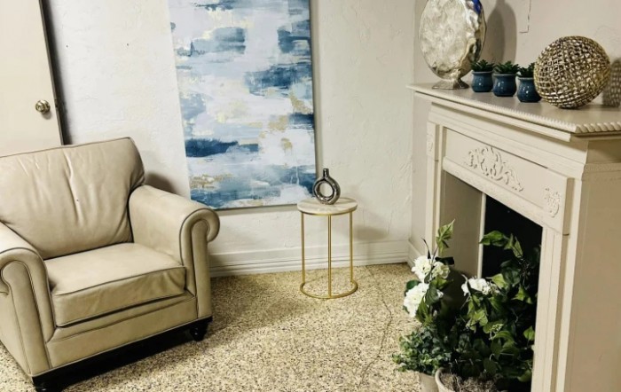 A cozy living room with a beige sofa, abstract artwork, and elegant decor.