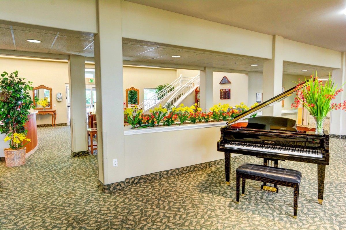 A grand piano in a well-decorated lobby area.
