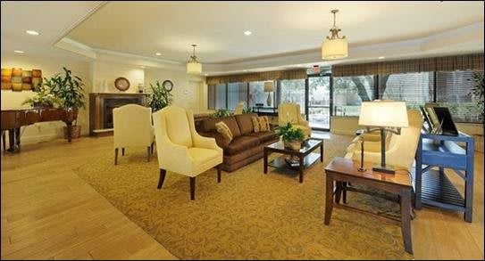 A cozy and elegantly decorated living room with comfortable seating and soft lighting.