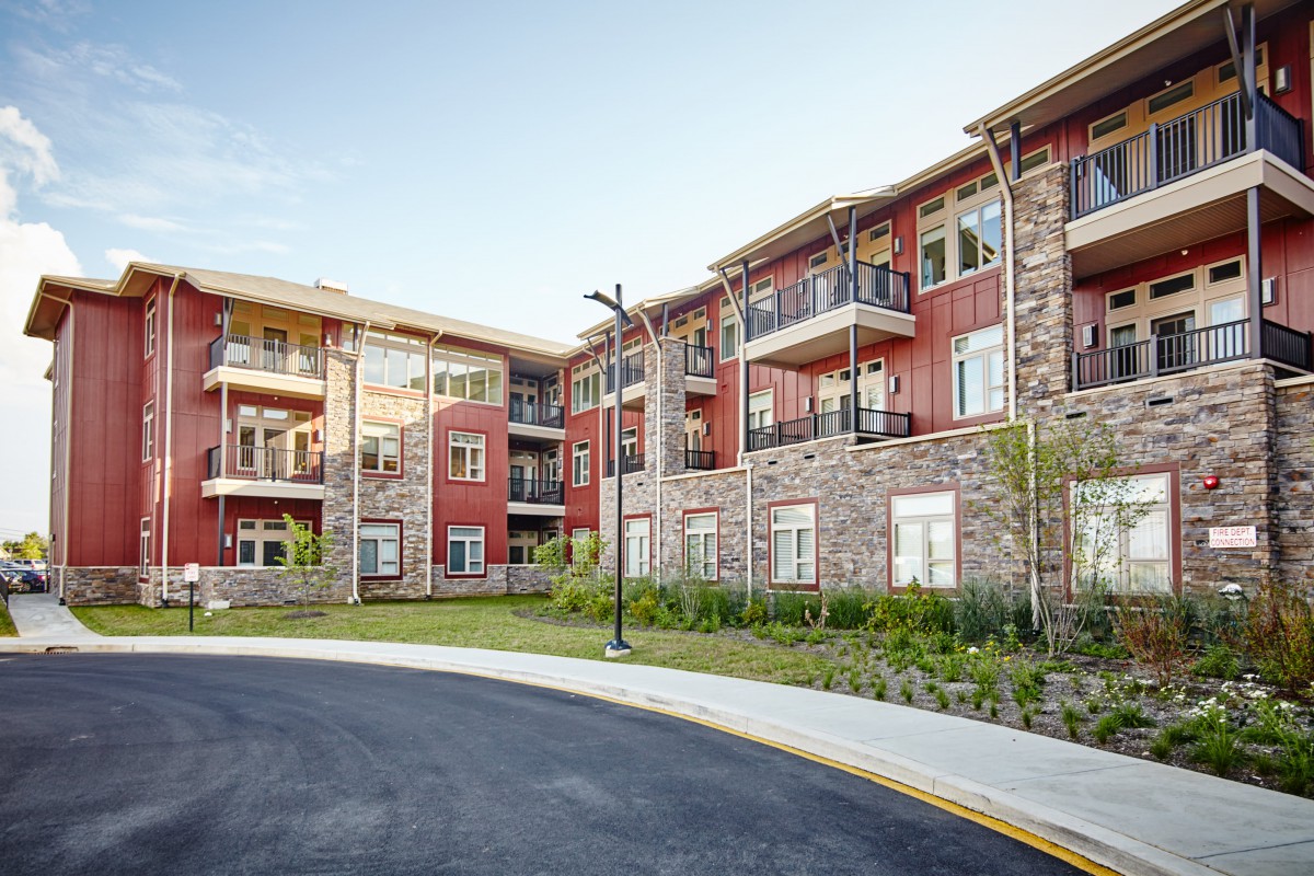 A modern residential apartment building with balconies and a well-maintained exterior.