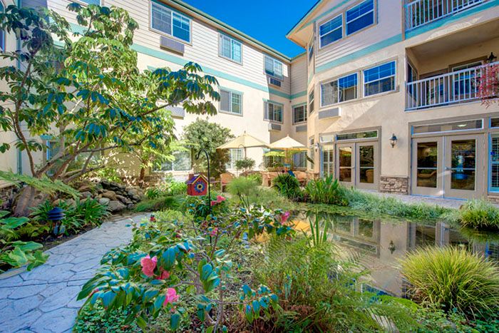 A serene courtyard with vibrant flowers at a residential building.